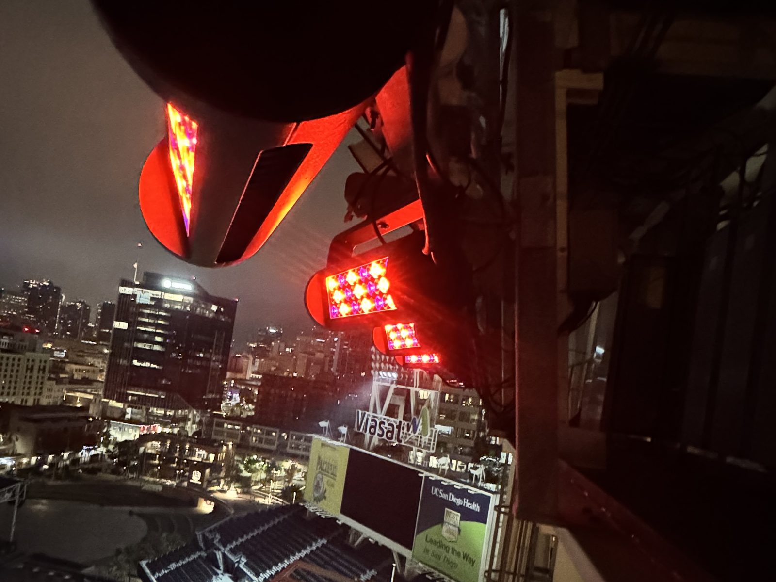 Reach Elite luminaires lit red on the Petco Park upper structure at night, downtown San Diego beyond